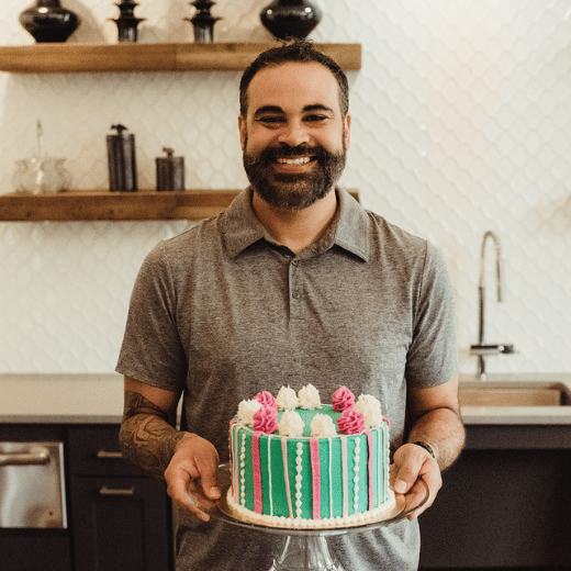Our baker holding a cake